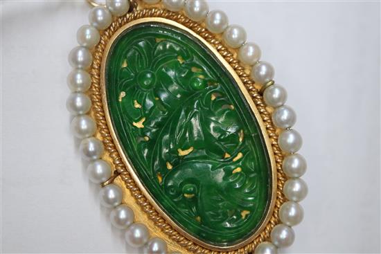 A 14k mounted jadeite and cultured pearl set oval pendant brooch, 5cm.